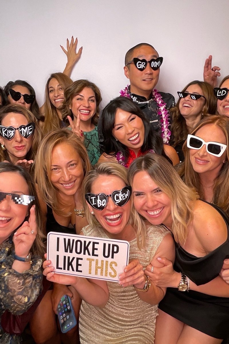 Wedding party having fun with photo booth props
